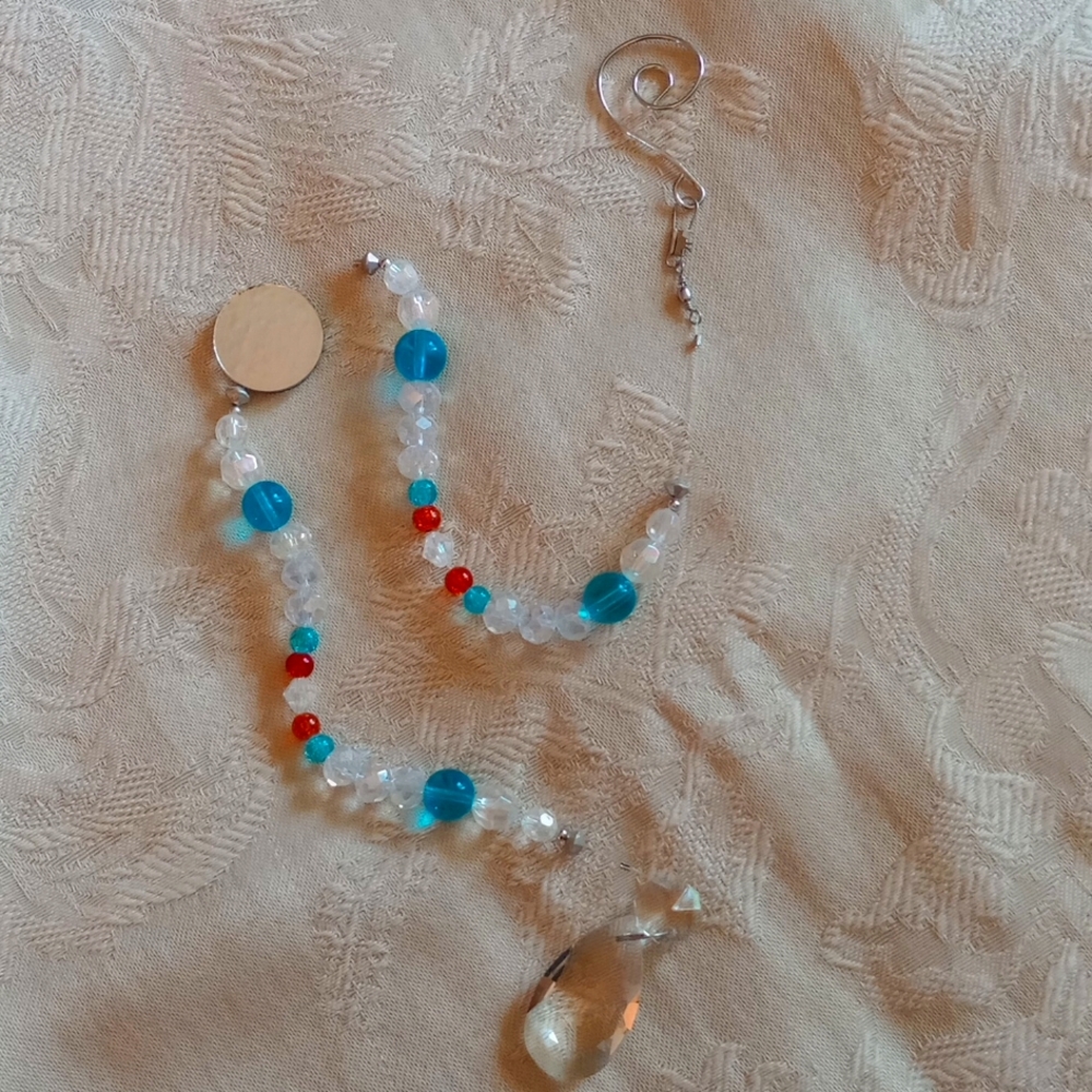 Handmade crystal Suncatcher. Orange, turquoise and clear crystals, 21" long.